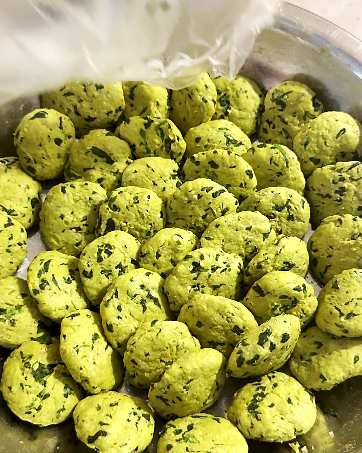 Green thepla dough divided into small balls